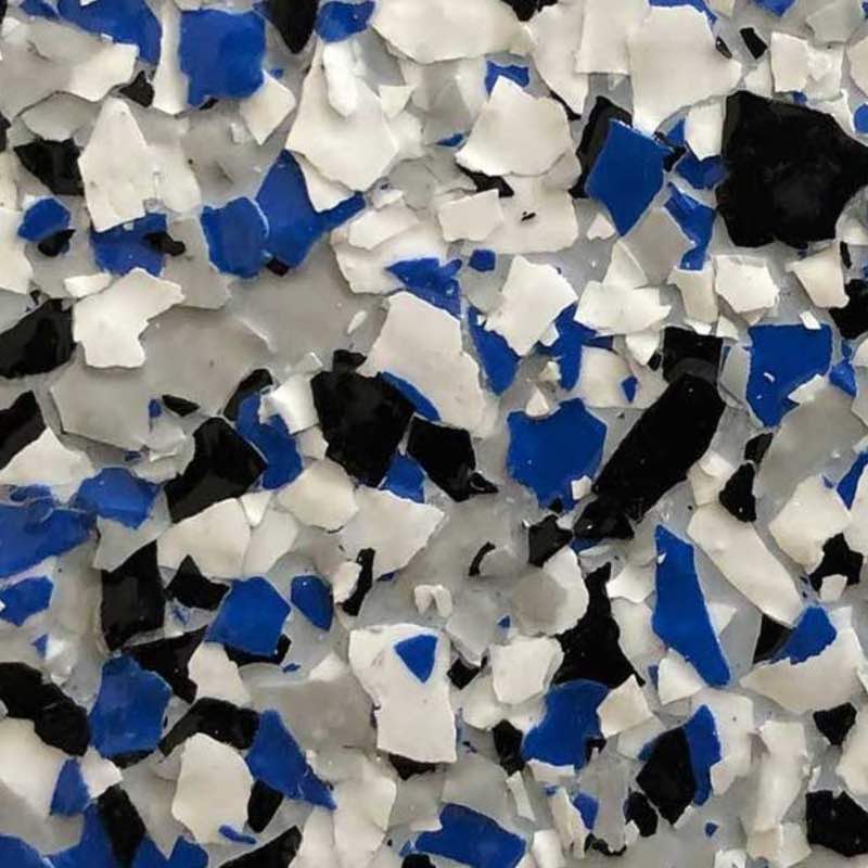 Epoxy residential floor full coverage blue, black, and white chips and flakes.