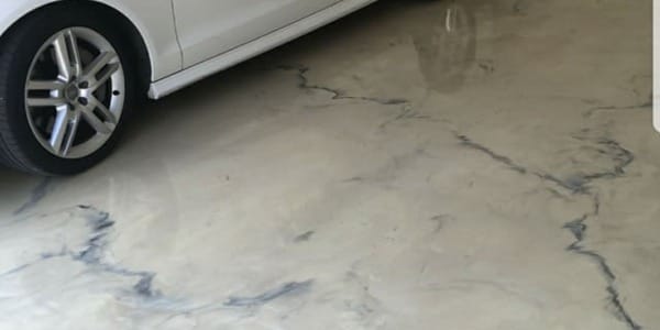 Garage floor liquid marble with veins and white car.