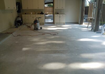 Colored garage floor epoxy sandstone project prepping.