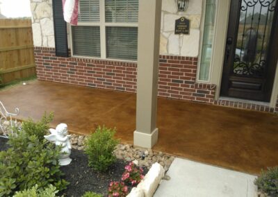 Copper residential stained concrete floors porch front door.