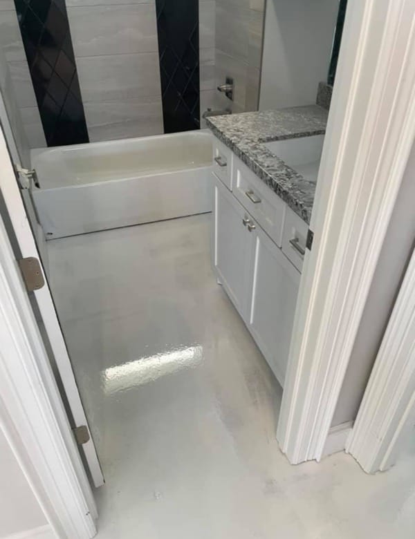 Epoxy flooring metallic bathroom.