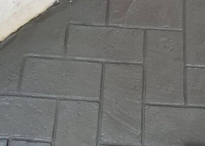 Herringbone brick stamped concrete grout lines.