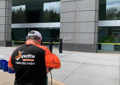 Non-slip concrete coating at Schlumberger building in Houston, TX, by Xpedite Coatings preparing project.