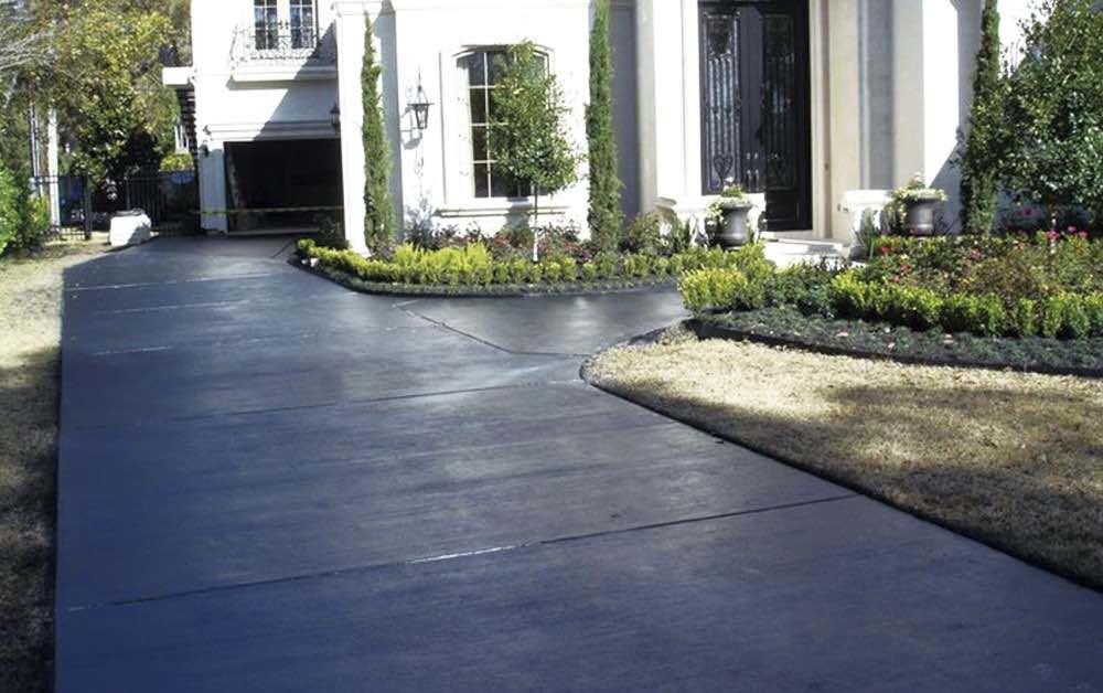 Residential stained concrete driveway black.